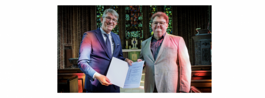 Kulturstaatsminister Wolfram Weimer (links) übergibt Pfarrer Andreas Döhle am 27. August 2026 die Förderurkunde für die denkmalgerechte Sanierung der Bekenntniskirche in Berlin-Treptow. Foto: BKM/photothek/Thomas Köhler
